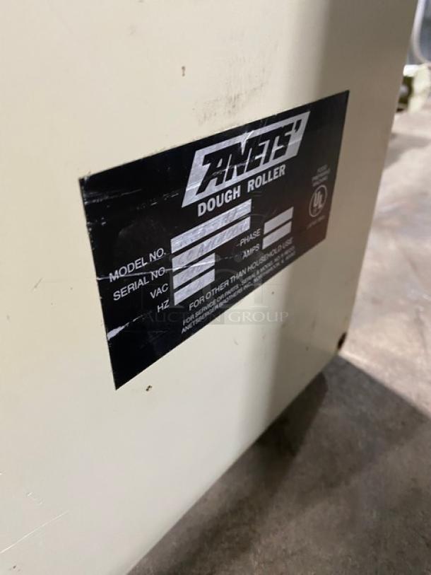 Anets commercial electric countertop conveyor-belt dough roller with visible label showing model and serial information.