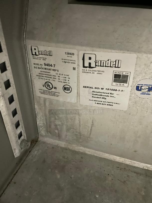 Randell commercial stainless steel undercounter refrigerator, model 9404-7, with poly coated wire rack, 115V, on casters, labels visible.