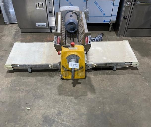Anets commercial electric countertop conveyor-belt dough roller/sheeter machine with dual folding trays and central motor unit.