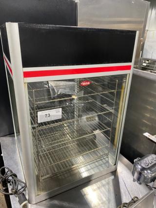 Hatco Flav-R-Savor FSDT-1X humidified display cabinet with 4-pan rack, glass front, 120V, stainless steel, model tag visible.
