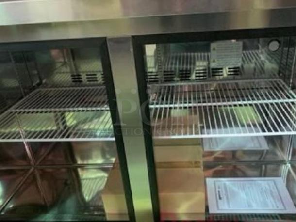Brand new Migali UR48 undercounter refrigerator, 2-door, 12 cu. ft., stainless steel, excellent condition, shelves visible.