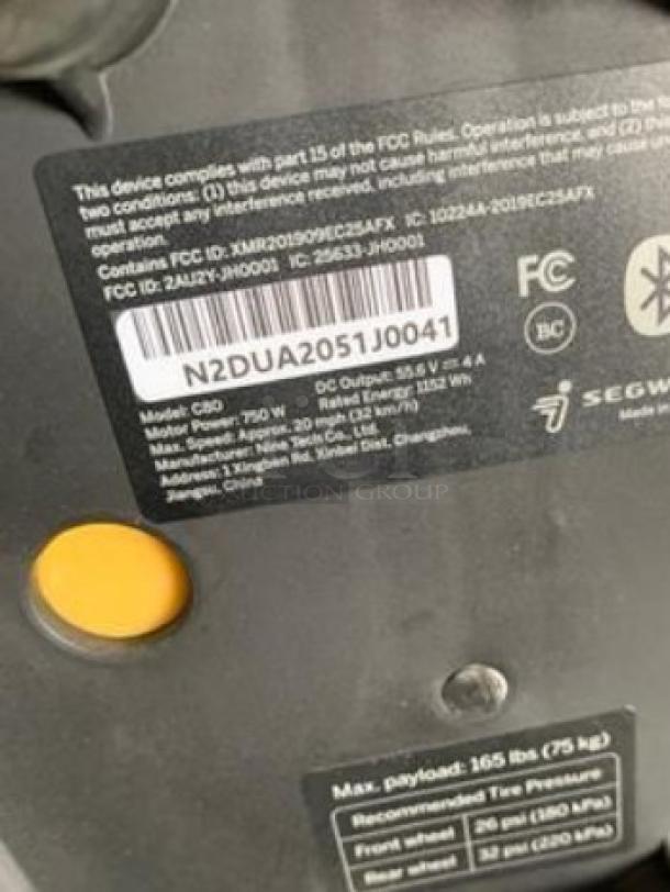 Close-up of Segway Ninebot eMoped C80 label showing model details, 750W motor power, and regulatory compliance information.