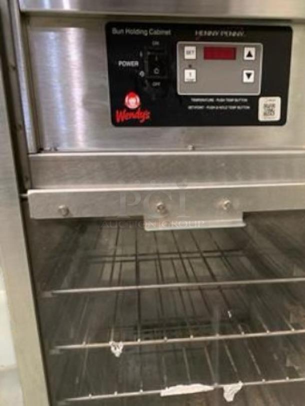 Henny Penny BW100 Bun Holding Cabinet, excellent condition, 120V, features Wendy's branding, digital controls, stainless steel shelves.