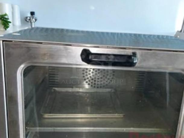 Adcraft COQ-1750W convection oven in excellent condition, 120V/1750W. Features stainless steel exterior and glass door. Fully tested.