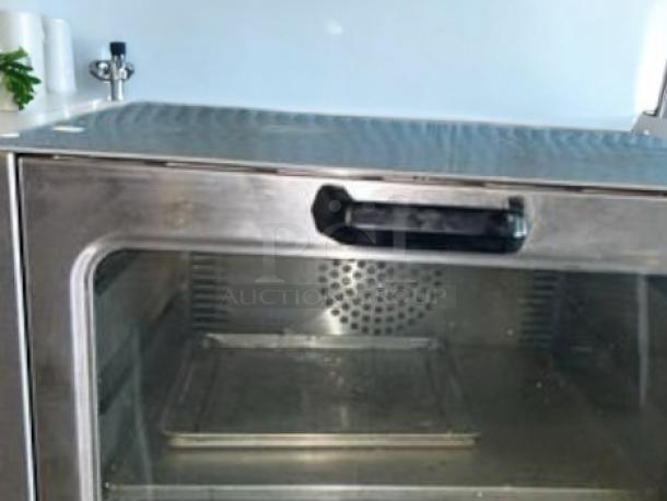 Adcraft COQ-1750W convection oven in excellent condition, 120V/1750W, with stainless steel exterior and clear front door.
