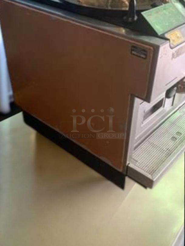 La Cimbali M2 espresso machine in excellent condition, 220V, fully tested. Features stainless steel body, control panel, and drip tray.