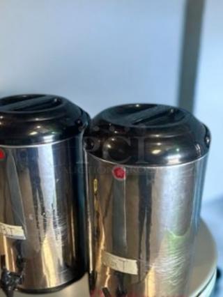 Two stainless steel commercial-grade beverage dispensers for hot/cold drinks, in excellent condition, fully tested, model shown.