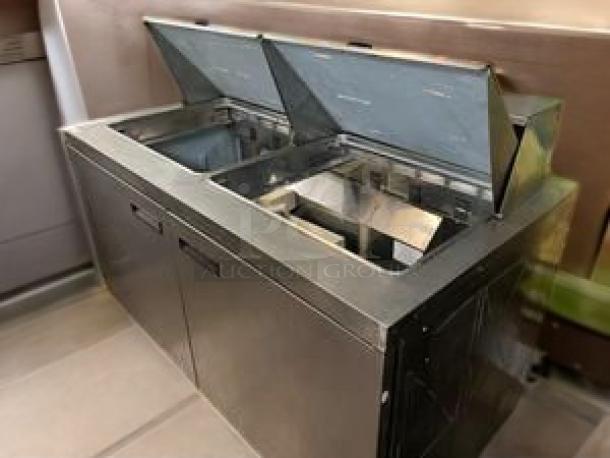 Delfield 2-door sandwich/salad prep table, excellent condition, fully tested, 115V AC. Dual compartment with hinged lids.