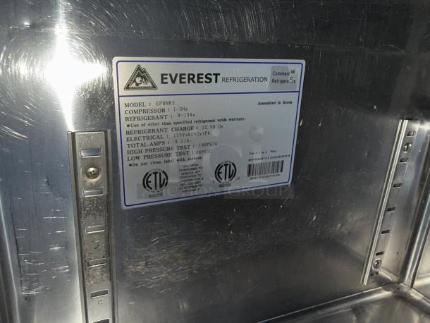 Alt text: "Everest EPBNR3 3-Door Refrigerated Sandwich Prep Table label, showing model and specifications, excellent condition."