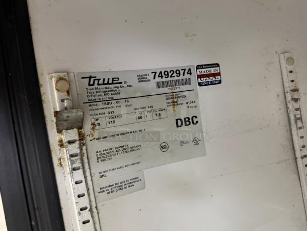 True TSSU-60-16 label on stainless steel sandwich/salad prep table. Model info, serial number 7492974, made in USA noted.