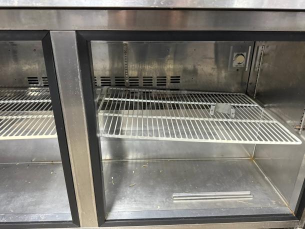 Blue Air 60" prep table, model BLPT60. Great condition, tested and working, stainless steel interior, wire shelving.