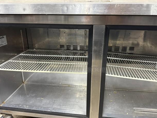Blue Air BLPT60 60" prep table in great condition, stainless steel, dual shelves, tested and working, interior view.