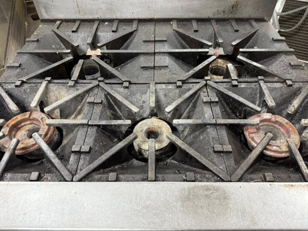 Southbend S36D 6-burner gas range with oven, natural gas, tested and working, good condition, slight wear visible.