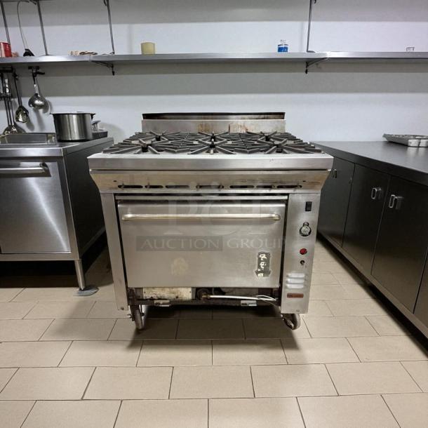 Montague 6-burner gas range with oven, excellent condition, natural gas, fully tested, stainless steel finish, commercial.