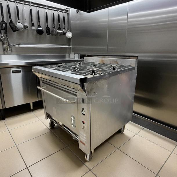 Montague 6-burner gas range with oven in excellent condition. Natural gas, fully tested, on wheels for mobility.