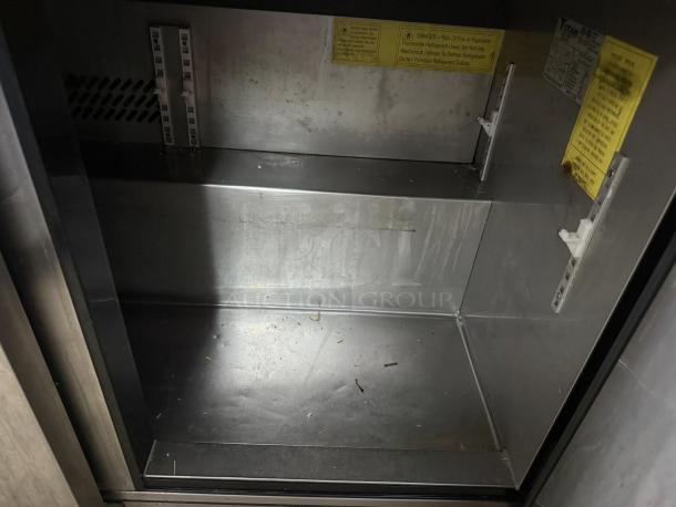 Titan XTSU72 72" 3-door sandwich prep table in great condition. Tested, working, 115v, 1ph. Interior view with caution labels.