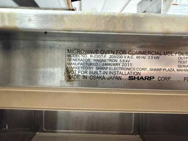 Sharp R-22GTF commercial microwave label. Model R-23GT-F, 208/230V, made in January 2011, by Sharp Corp, Japan.