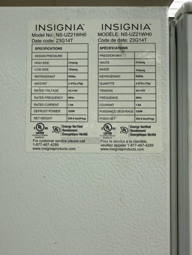 Insignia 21 Cu. Ft. convertible upright freezer, model 23G14T, in white. ENERGY STAR certified. Tags show model and specs.