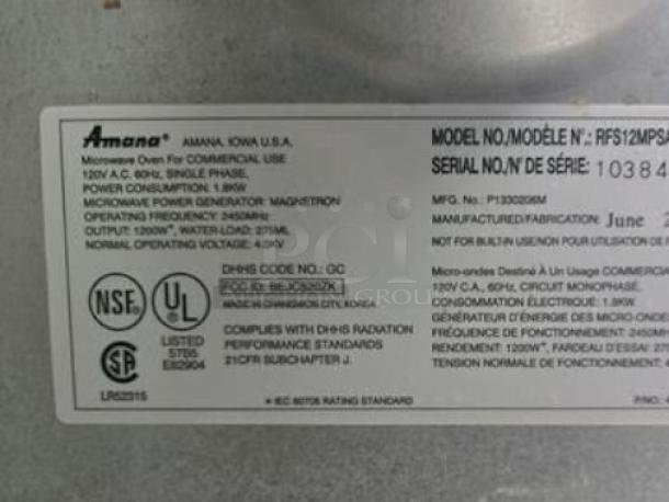 Label on Amana RFS12MP-SA commercial microwave oven showing model, serial number 103840858, and certification marks.