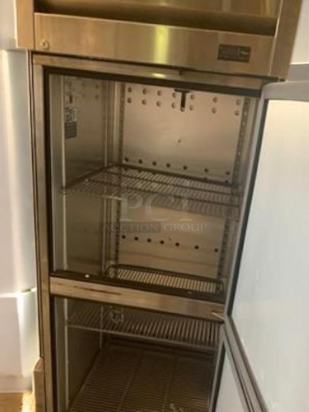 True T-23F-HC reach-in freezer with half-doors, excellent condition, shelves visible, stainless steel interior, 115V.