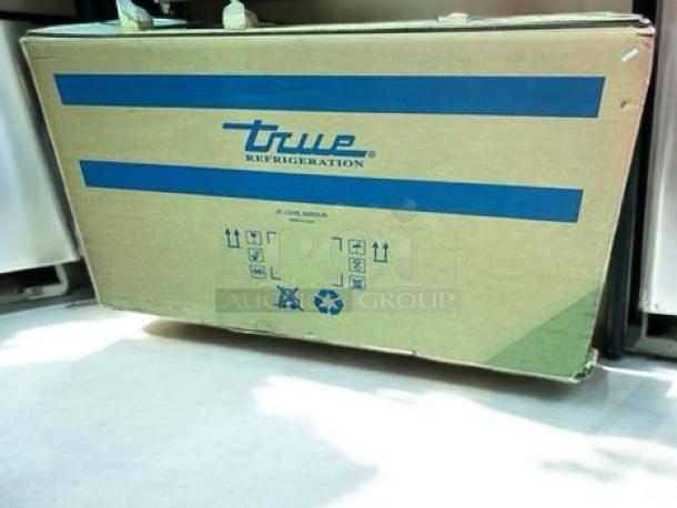 Boxed True TWT-72-HC 72" worktop refrigerator, three doors, brand new, fully tested. True logo on packaging.