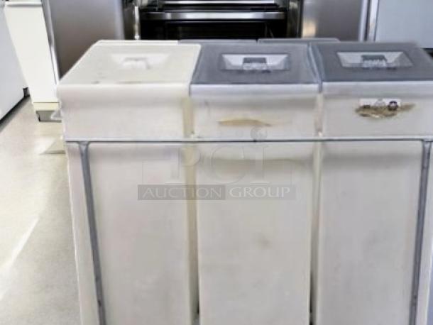Faribo Ingredient 3-Bin Cart in good condition with stainless steel frame and sliding covers; includes casters for mobility.