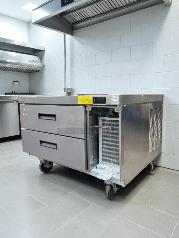 Randell 2-drawer refrigerated chef base in excellent condition, 115V, fully tested, open side panel, casters, metal finish.