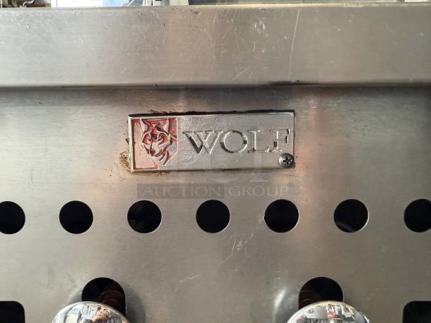 Wolf Gas Charbroiler in excellent condition, 120V ignition, heavy-duty commercial countertop model. Brand logo visible.