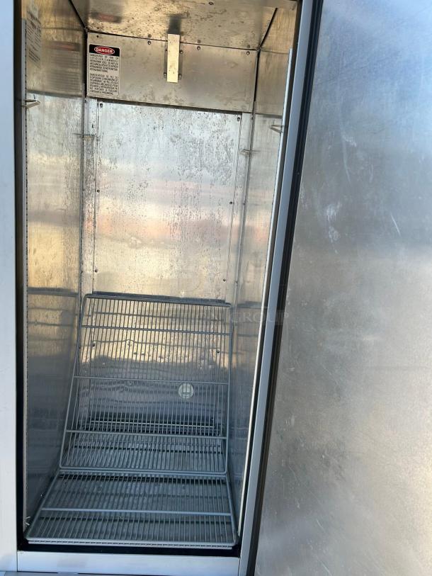 Economy EF1A-FS single door commercial freezer, excellent condition, 115V, wire racks, visible safety label inside.