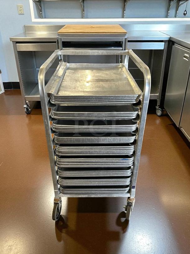 Half-size bakery speed rack in like-new condition, featuring multiple slots for sheet pans, durable wheels, stainless steel frame.