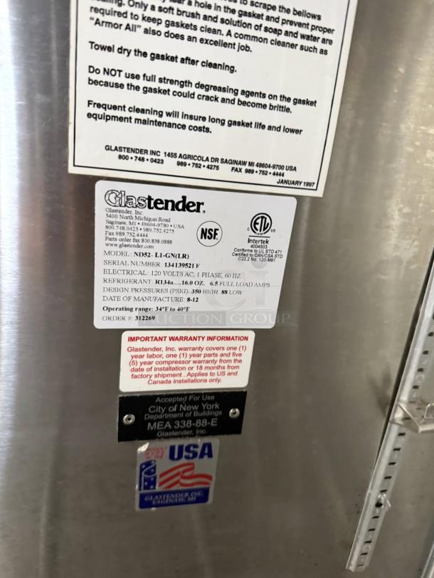 Glastender C2FB60 silver refrigerated cabinet with two glass doors. Labels indicate NSF, ETL certifications, made in USA.
