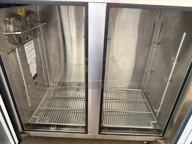 Glastender C2FB60 silver refrigerated back bar cabinet, two glass doors, tested and working, interior shelves visible.