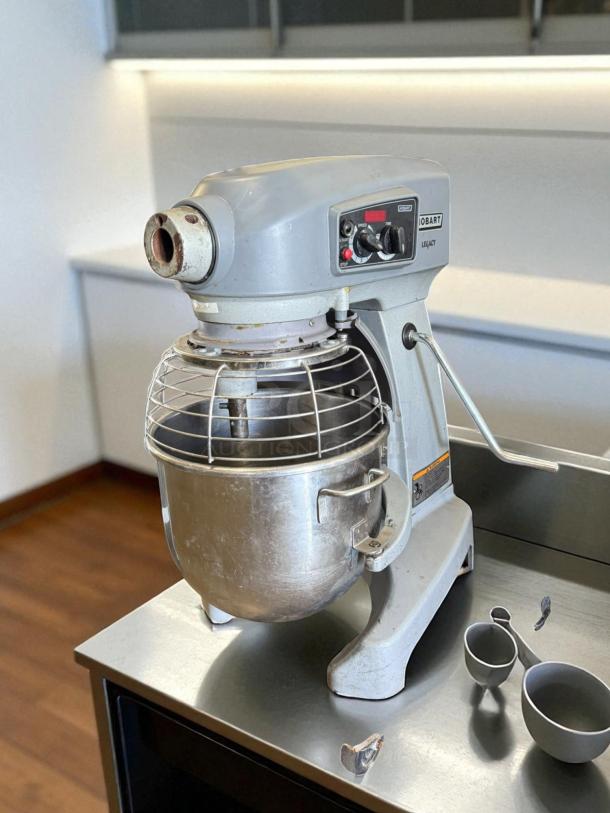 Hobart A200 20 QT dough mixer, 115V single phase, tested and working. Features sturdy metal bowl, control panel, and safety guard.