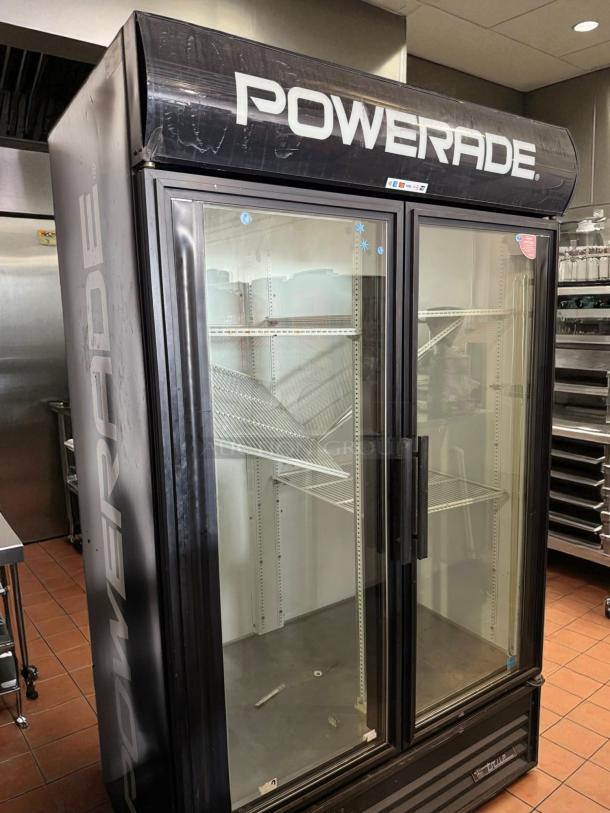 True GDM-43 glass door merchandiser, 47 1/8", two-section, left/right hinge doors, white, Powerade branding, tested, working.