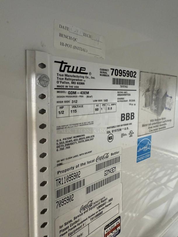 True GDM-43 glass door merchandiser label, model GDM-43EM, 115v, with serial number 7095902 and Energy Star sticker visible.