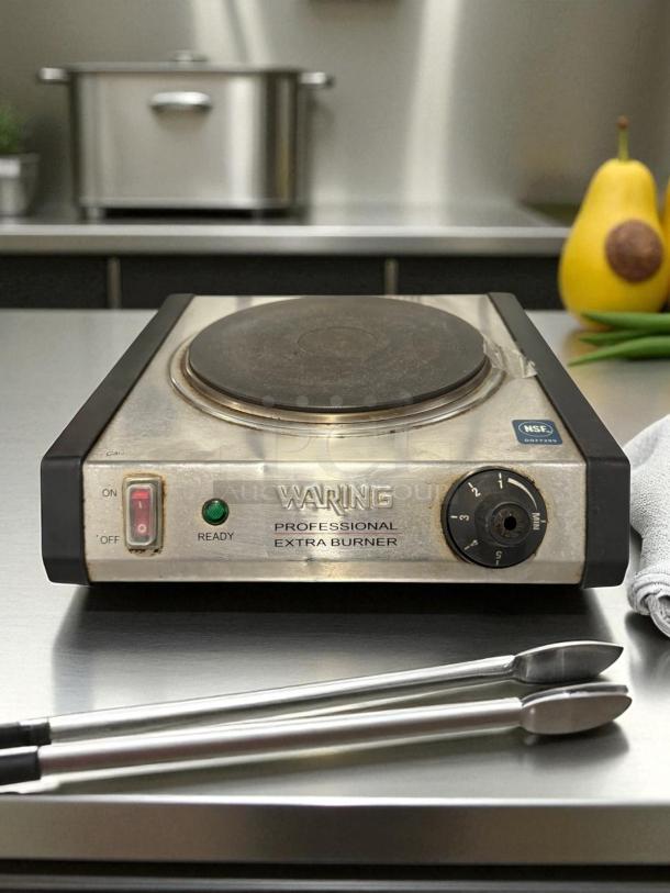 Waring WEB300 single burner solid top range, 1300W, great condition, tested and working. Features controls and NSF label.