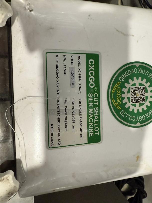 CXCGO Electric Onion Cutter, Model XC-188A, tested working, 110V, 135kg. Features label detailing specs and manufacturer info.