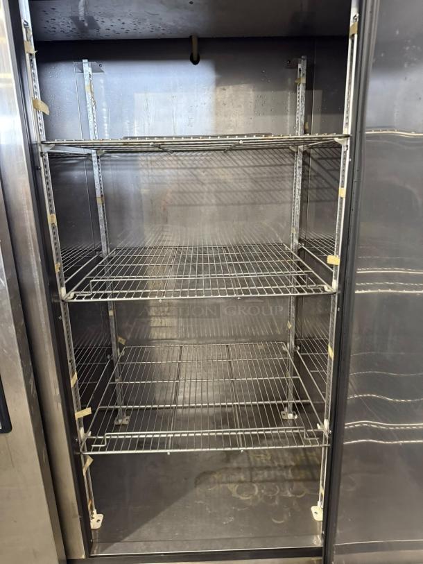 Turbo Air TSR-72SD-N refrigerator interior with three metal shelves, left/right hinged solid doors, in excellent condition.