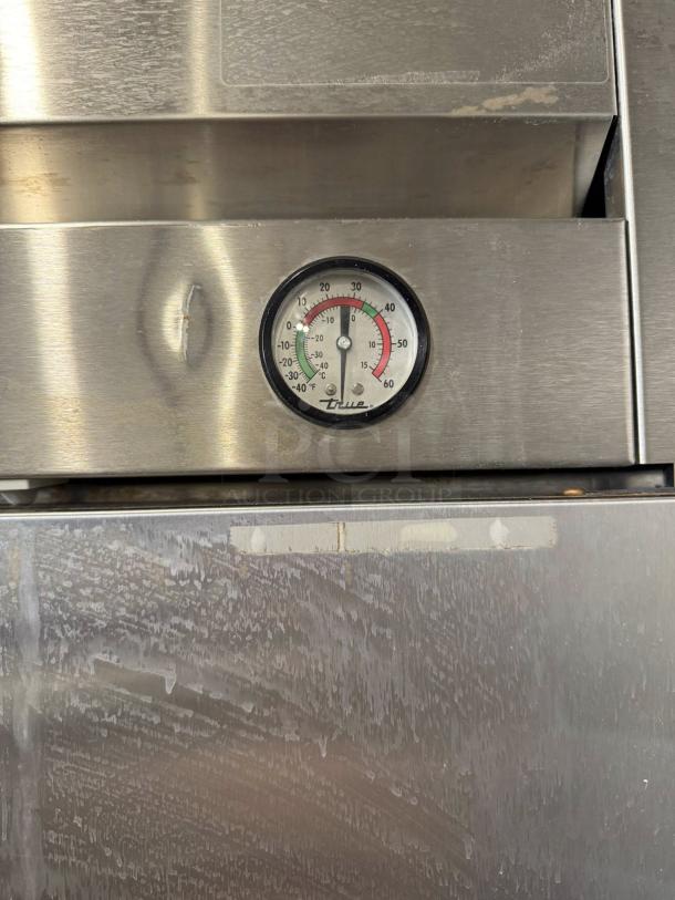 True T-49-HC refrigerator, dual solid doors, temperature gauge visible, stainless steel, minor dent, tested, 115v.