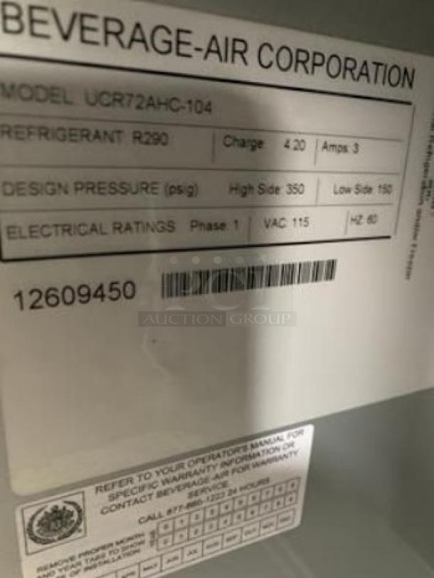 Label on Beverage-Air UCR72AHC-104 refrigerator showing model, refrigerant type, design pressure, and electrical ratings.