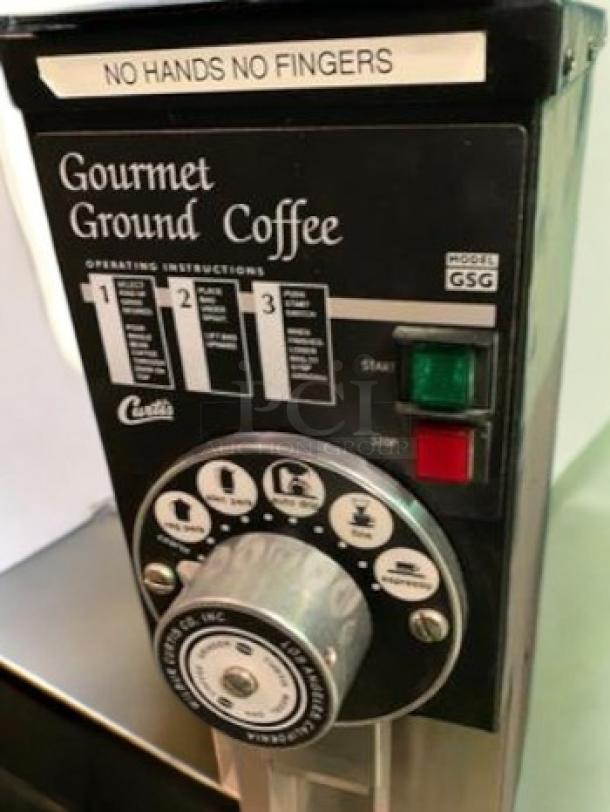 Wilbur Curtis GSG-3BLK coffee grinder in excellent condition. Features control panel, "No Hands No Fingers" label, 120V.