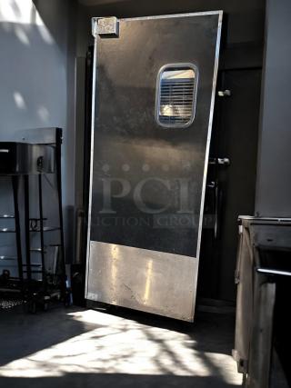Eliason 36"x80" black heavy-duty single swing traffic door, excellent condition, fully operational with inspection window.