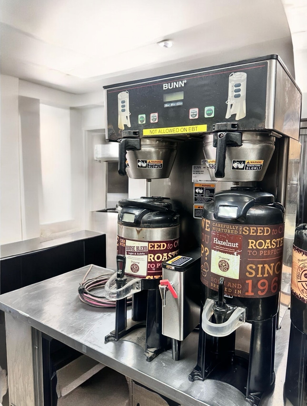 Multi-head commercial coffee brewing system with multiple dispensers showing variety options