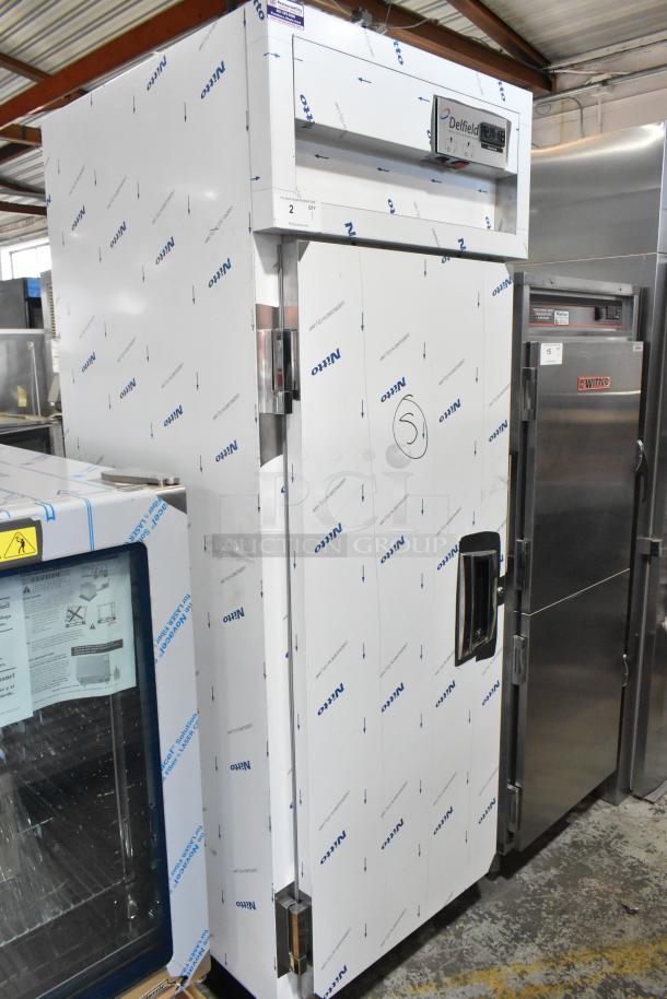 BRAND NEW SCRATCH AND DENT Delfield SAH1-S3-207 heated cabinet, stainless steel, 240V, single door, protective wrap visible.