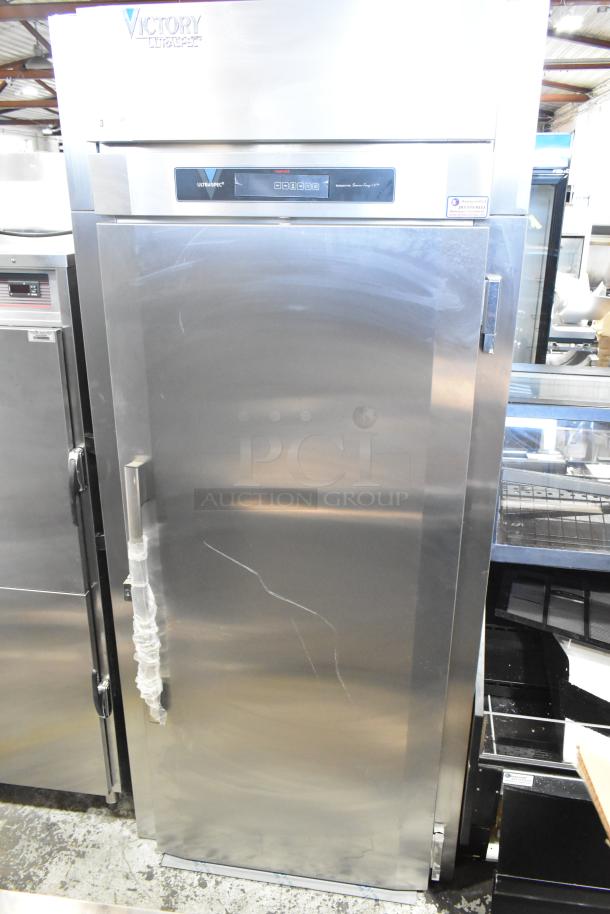 Brand new Victory HIS-1D-1-PT stainless steel commercial single door pass-through heated cabinet, 115V, slight dents visible.