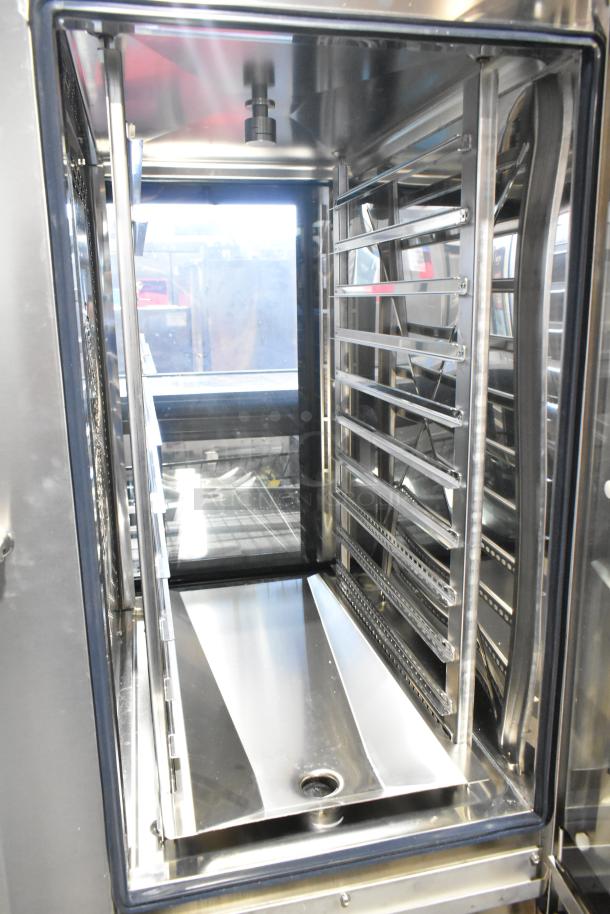 BRAND NEW BKI AETE101DF stainless steel combi convection oven, 208 volts, 3 phase, visible racks, minor scratches.