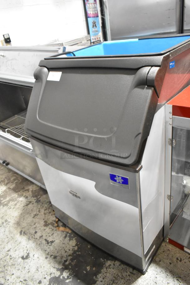 Brand new Manitowoc D570 stainless steel ice storage bin, 532 lb capacity, minor scratches and dents visible.