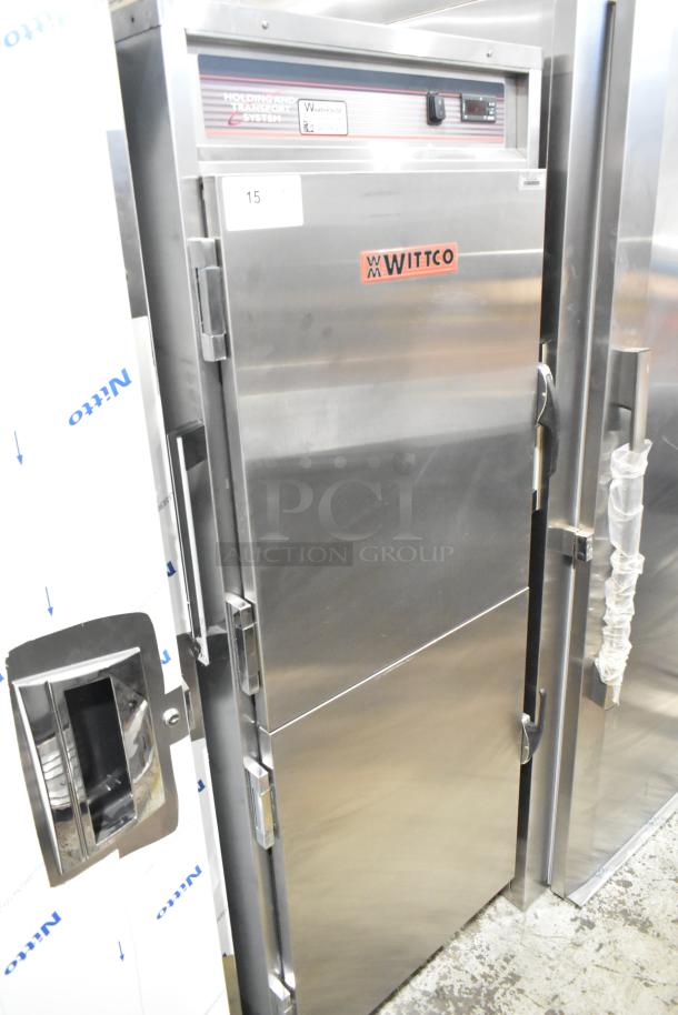 Winco 1826-15-DD-GD-PT-IS stainless steel heated holding cabinet, 2 half-size doors, on commercial casters, 120V, 1 phase.