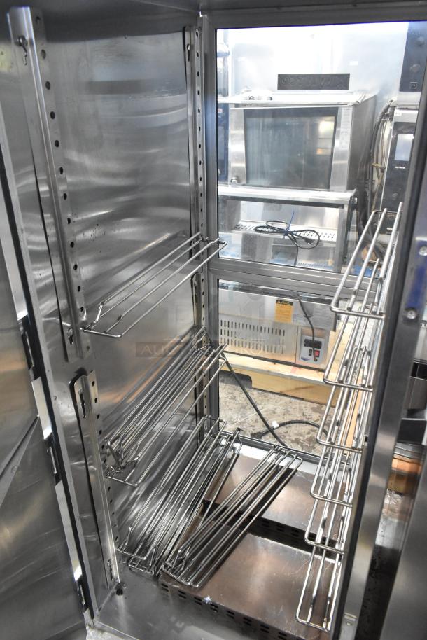 Winco 1826-15-DD-GD-PT-IS stainless steel heated holding cabinet, interior view with adjustable racks, on commercial casters.