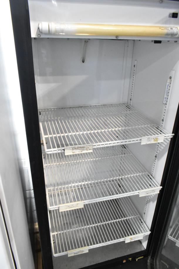 True GDM-12 reach-in cooler merchandiser, metal frame, single door, poly-coated racks, 115V, 1 phase, good condition.